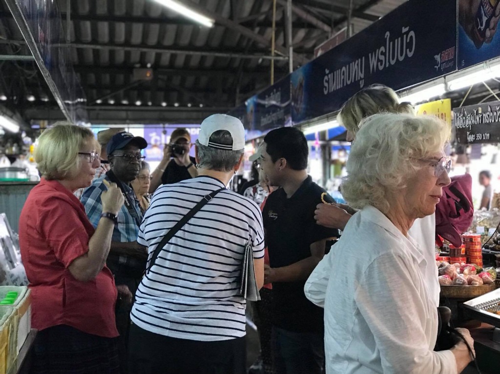 Market tour guide with foreign visitors
